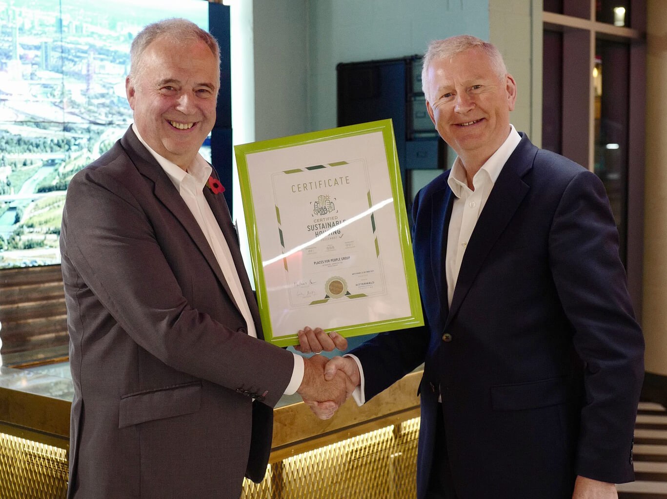 David Cowans, CEO of Places for People is presented with the Certified Sustainability Housing Label by Austen Reid, the UK Director of Ritterwald Consulting at the COP26 Fringe Event in London.